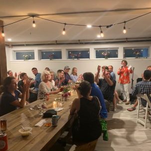 A crowd celebrates at the Mt. Rainbow Community Room